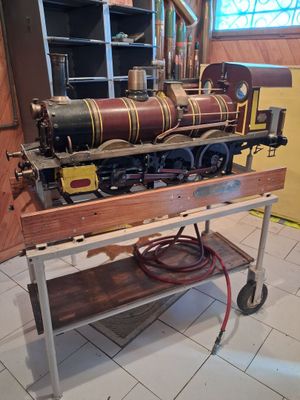 a model train sitting on a cart in a room