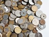 a pile of coins sitting on a white surface