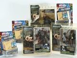 five action figures of different sizes and colors in the package