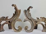 a pair of ornate wooden sculptures on a white surface