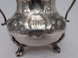 a silver vase that is sitting on a table