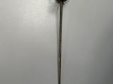 an old sword with a gold handle on a white wall