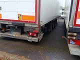 two trucks that are parked on the side of the road