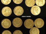 several different types of gold coins are shown on a black surface