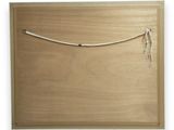 a close up of a wooden box with a string on it