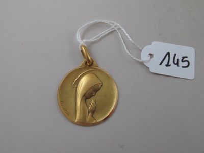 a close up of a gold medal with a bird on it