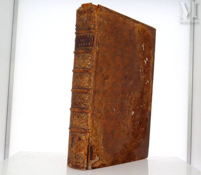 an old book sitting on top of a white table
