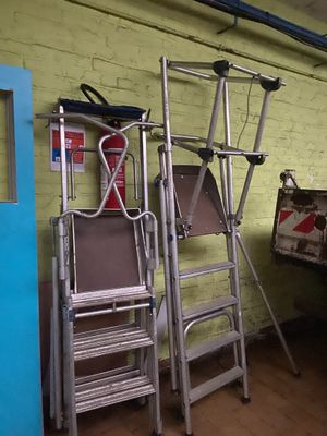 two ladders that are next to each other in a room
