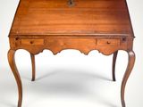 an old wooden desk with a drawer on top of it