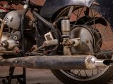 an old motorcycle that is parked in a garage