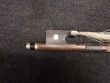 a wooden stick with a long handle and a long string