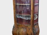 a wooden display cabinet with glass doors on it