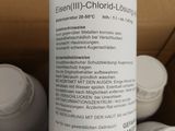 a bottle of liquid sitting on top of a cardboard box