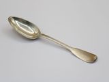 silver spoon on a white surface with a small spoon sticking out of it