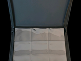 a open suitcase with a lot of white tiles inside of it