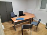 an image of an empty office with a desk and chairs