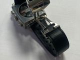 a close up of a watch on a white surface