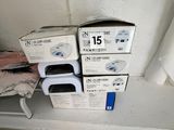 two boxes of microwaves sitting on a shelf in a bathroom