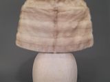 a close up of a lamp with a fur covering on top of it