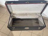 a black suitcase sitting on a tiled floor in a room