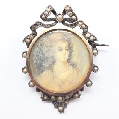 an image of a picture of a woman in a crown on a broocher