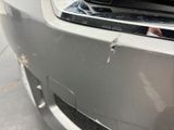 a close up of a car ' s front bumper with a hole in it