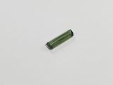 a small piece of green glass sitting on top of a white surface