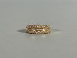 a close up of a pair of gold rings on a white surface