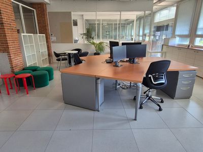 a desk with two computers and a chair in a room