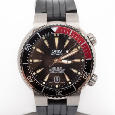 a close up of a watch on a white surface