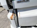 a close up of a truck ' s front bumper with rust on it