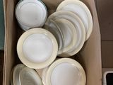 a box full of plates sitting on top of a counter
