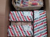 a box full of assorted skateboards sitting on the ground