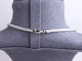 a close up of a silver necklace on a mannequin mannequin