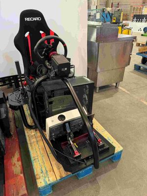 a car racing simulator on a pallet in a warehouse