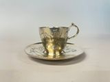 a close up of a cup and saucer on a table