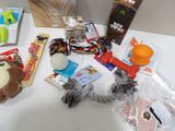 a table with various items that include a stuffed animal, a dog toy, and other items
