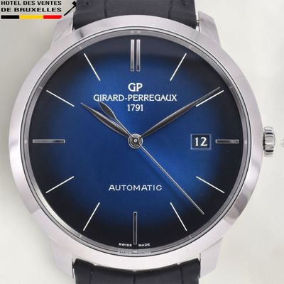 a close up of a wrist watch with a blue dial