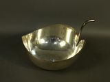 an image of a silver bowl with a spoon in it