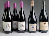 several bottles of wine are lined up on a table