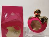 a pink perfume bottle sitting on top of a table next to a pink box