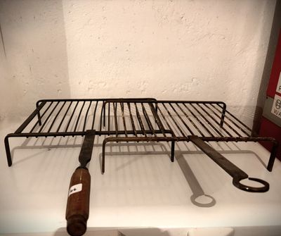a rack with a bottle of wine and a pair of scissors on it