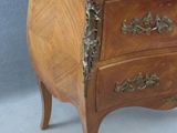 a marble top chest of drawers on a wooden stand