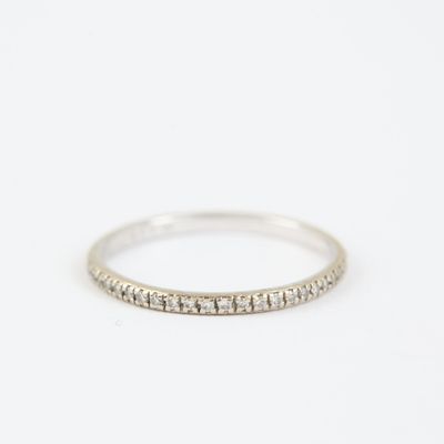 a white gold wedding band with small diamonds