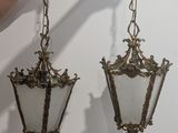pair of antique brass hanging lamps with frosted glass shades