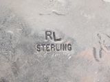 a close up of a piece of metal with the words rl smerling on it