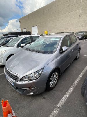 cars parked in a parking lot in front of a building