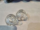 two empty wine glasses on the table next to a wine rack