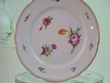 a plate with flowers on it sitting on a table
