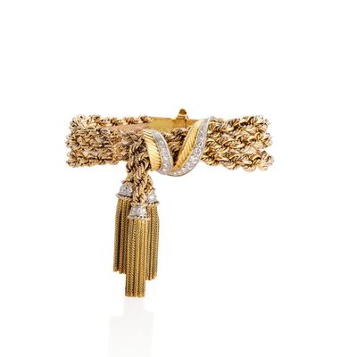 a close up of a gold and diamond ring on a white background